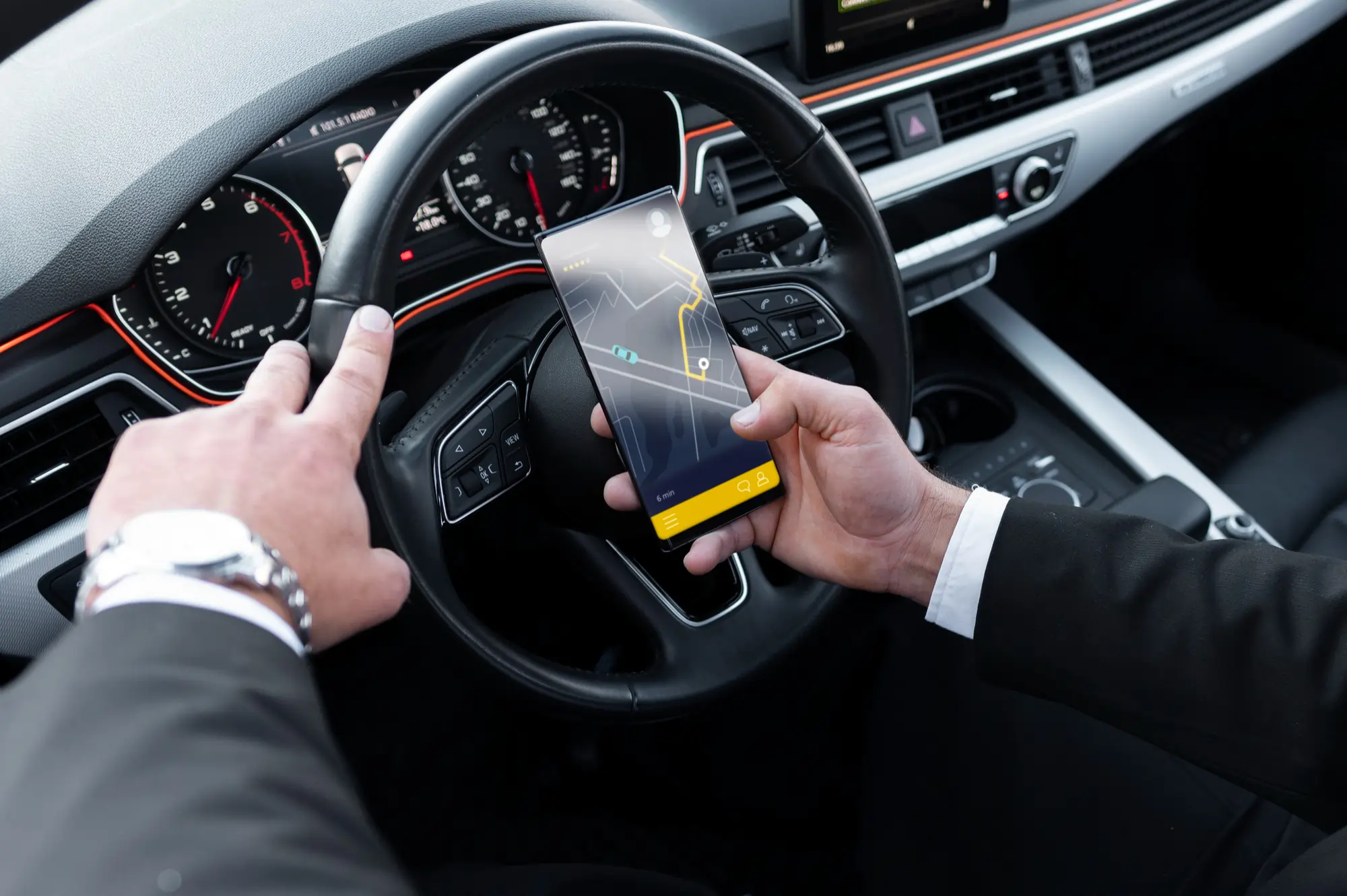 Private driver checking navigation app while driving for private driver services in Tirana and Durres